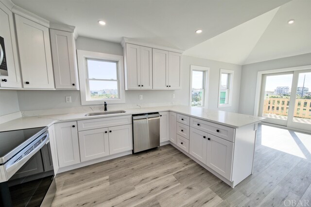 56185 Cedar Ave Lot 5, Hatteras, NC 27943 - kitchen featuring stainless steel appliances, a peninsula, a sink, light wood-style floors, and white cabinets