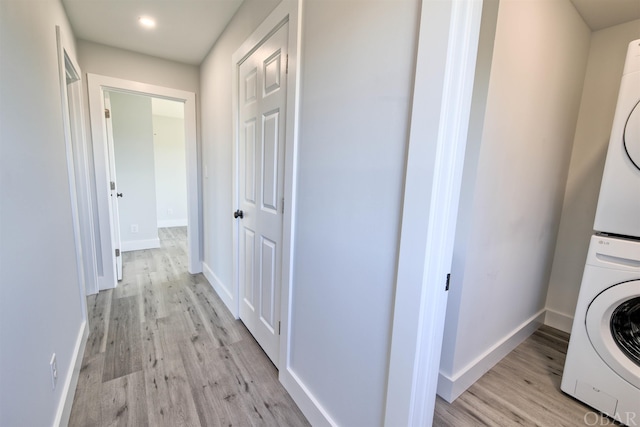 56185 Cedar Ave Lot 5, Hatteras, NC 27943 - laundry room with stacked washer and dryer, light wood-type flooring, laundry area, and baseboards