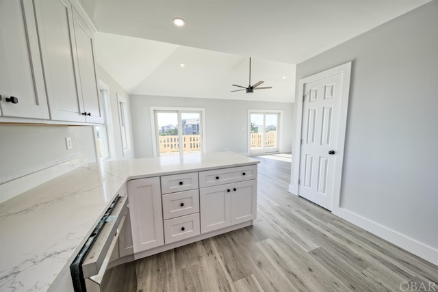 56185 Cedar Ave Lot 5, Hatteras, NC 27943 - kitchen with light stone counters, dishwashing machine, white cabinets, light wood-type flooring, and baseboards