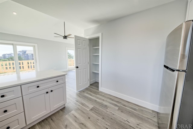56185 Cedar Ave Lot 5, Hatteras, NC 27943 - kitchen featuring light countertops, freestanding refrigerator, white cabinetry, light wood-type flooring, and baseboards