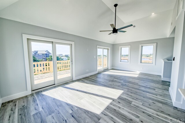 56185 Cedar Ave Lot 5, Hatteras, NC 27943 - unfurnished living room featuring a ceiling fan, light wood-type flooring, vaulted ceiling, and baseboards
