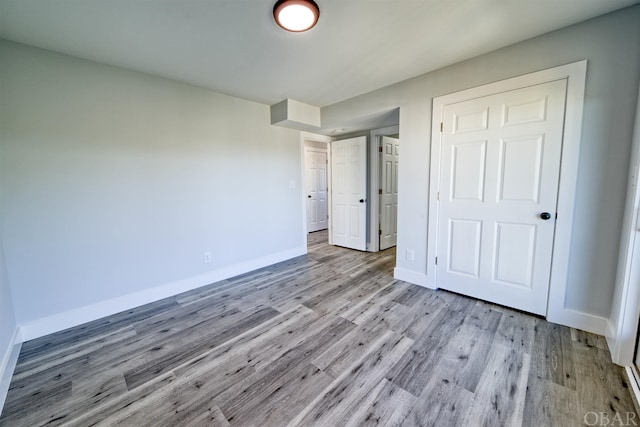 56185 Cedar Ave Lot 5, Hatteras, NC 27943 - unfurnished bedroom featuring light wood-style floors and baseboards