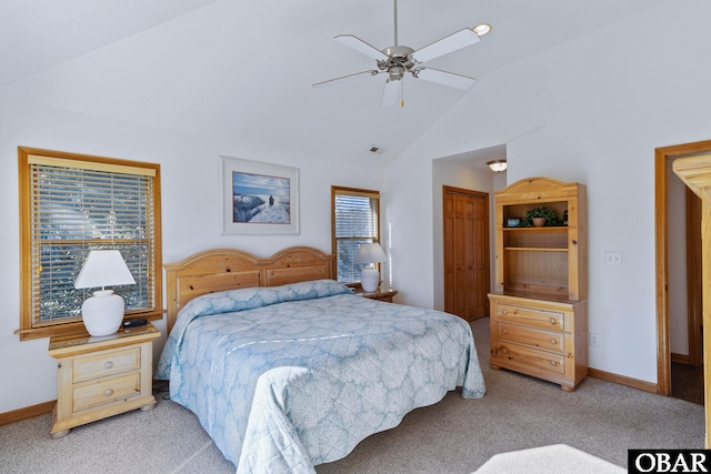 bedroom featuring a ceiling fan, baseboards, vaulted ceiling, a closet, and light carpet