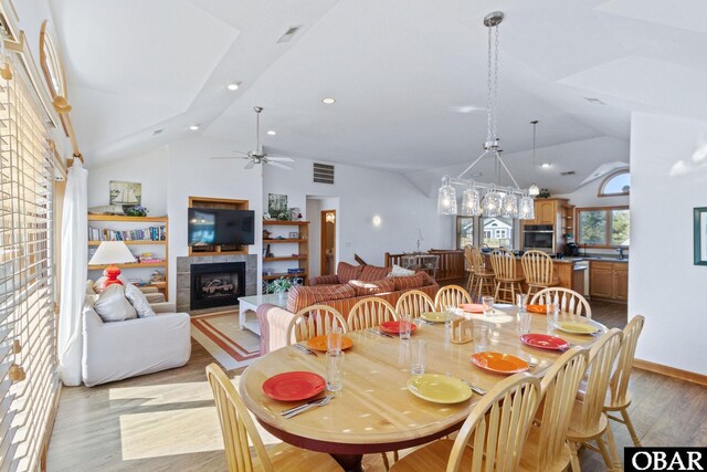 dining area featuring recessed lighting, a fireplace, visible vents, and light wood-style floors