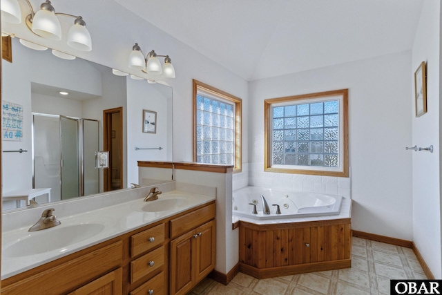 full bathroom featuring vaulted ceiling, a shower stall, a sink, and tile patterned floors