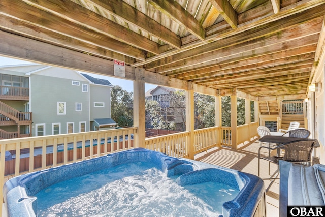 deck with an outdoor hot tub