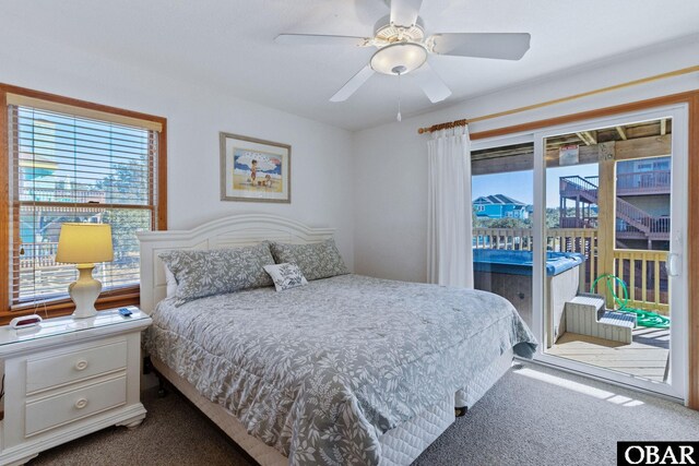 carpeted bedroom with access to outside, multiple windows, and a ceiling fan