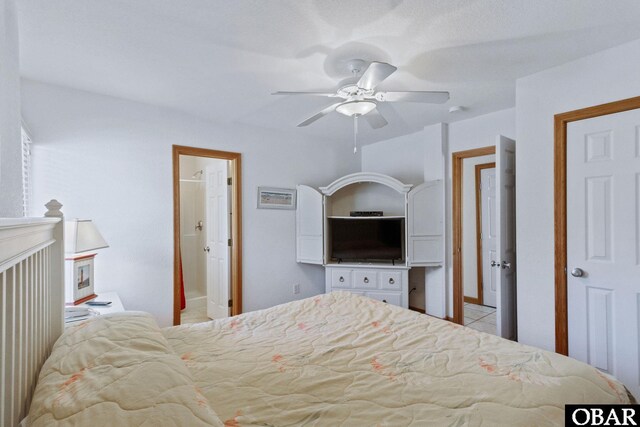 bedroom with a ceiling fan, connected bathroom, and light tile patterned floors