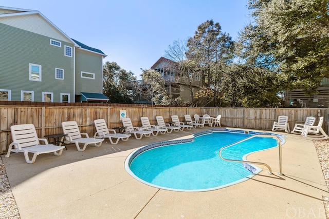 view of swimming pool featuring a fenced in pool, a patio area, and fence