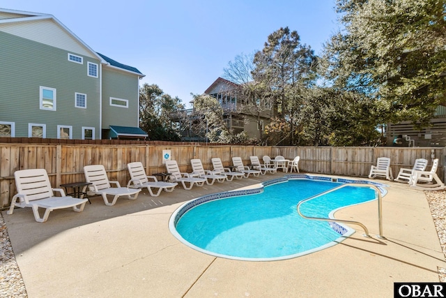 view of swimming pool featuring a patio, a fenced in pool, and a fenced backyard