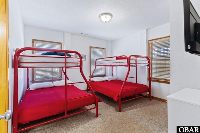 bedroom with carpet floors and baseboards