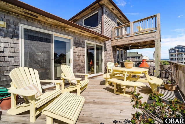 wooden terrace featuring outdoor dining area