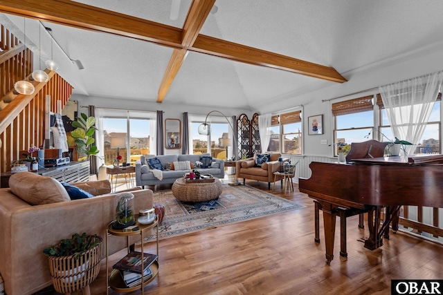 living area featuring wainscoting, plenty of natural light, wood finished floors, and stairway