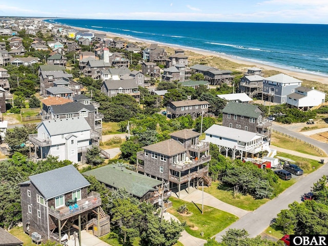 drone / aerial view featuring a beach view and a water view