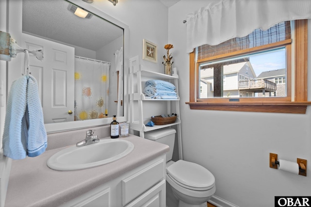 bathroom featuring toilet, a shower with shower curtain, and vanity