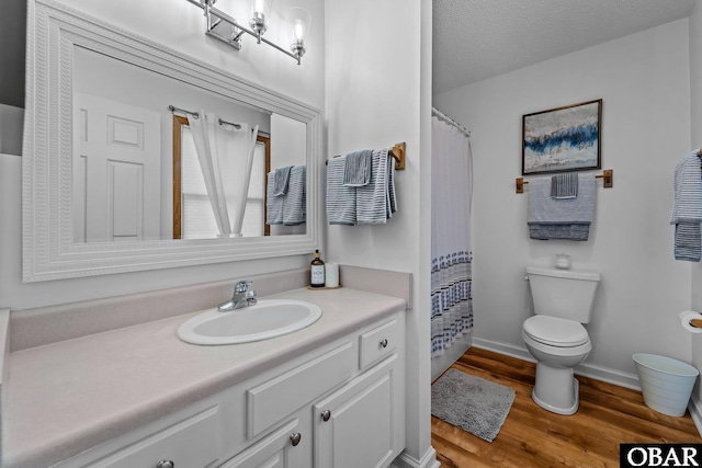 bathroom featuring vanity, toilet, baseboards, curtained shower, and wood finished floors