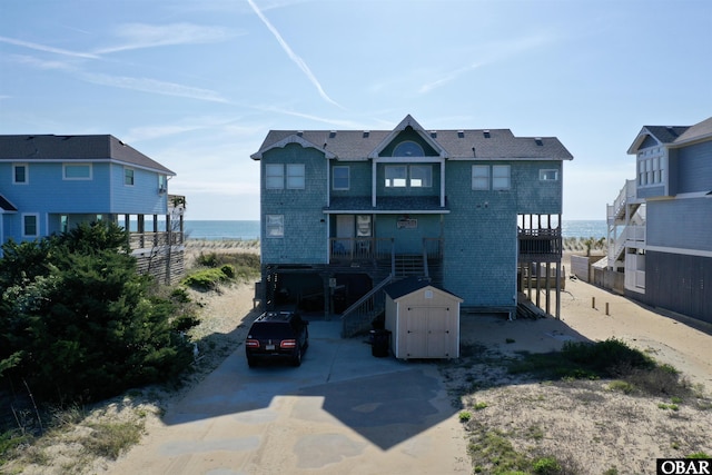 41133 Ocean View Dr Lot 13, Avon, NC 27915 - back of property with a water view, stairway, driveway, and a storage unit