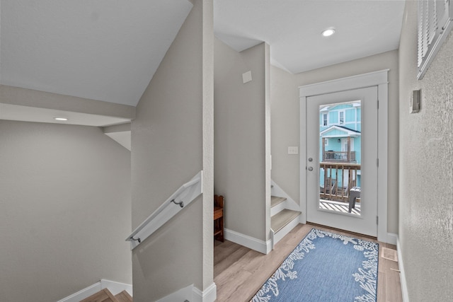 entryway featuring light wood finished floors, stairway, recessed lighting, and baseboards