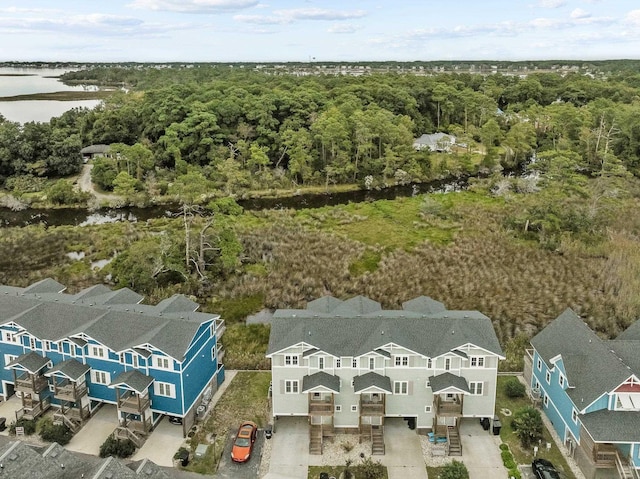 drone / aerial view with a forest view and a residential view