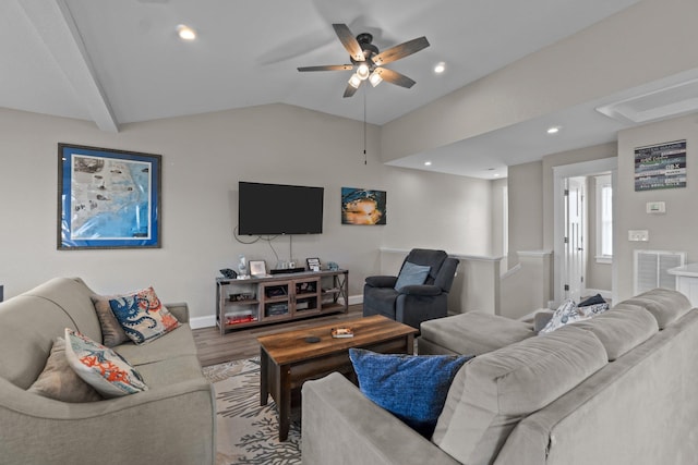 living area featuring lofted ceiling, wood finished floors, visible vents, baseboards, and a ceiling fan