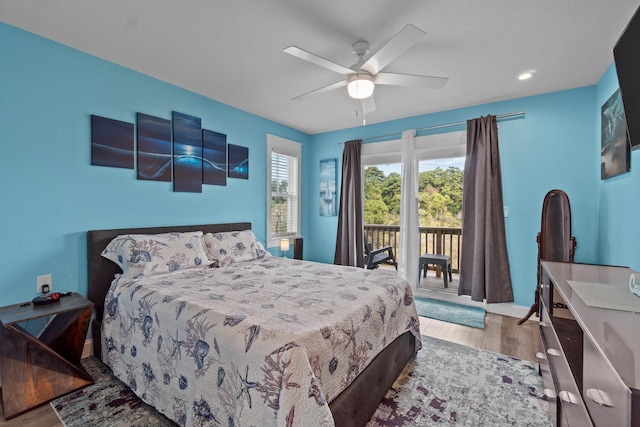 bedroom featuring ceiling fan, wood finished floors, and access to exterior