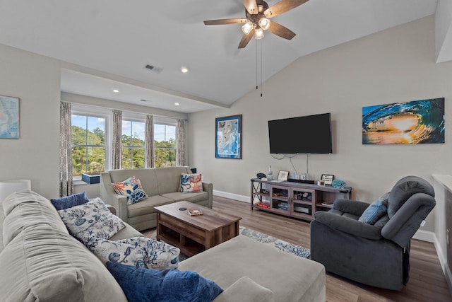 living area with lofted ceiling, visible vents, ceiling fan, wood finished floors, and baseboards