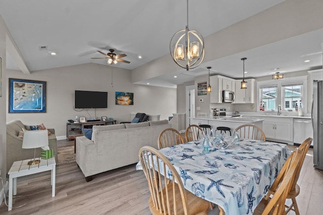 dining room featuring recessed lighting, visible vents, vaulted ceiling, and light wood-style flooring