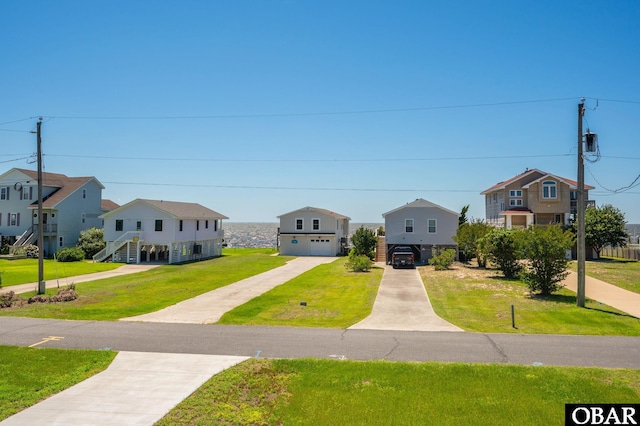 1804 Harbour View Dr Lot 91-O, Kill Devil Hills, NC 27948 - coastal home featuring a garage, a residential view, concrete driveway, a front yard, and stairway