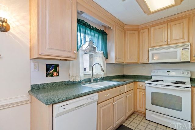 kitchen featuring dark countertops, white appliances, a sink, and light brown cabinetry