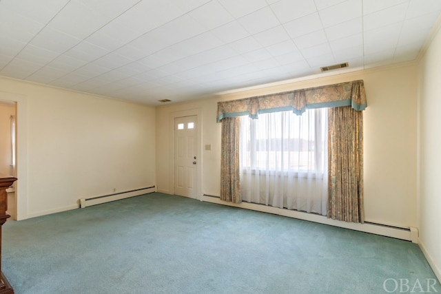 spare room featuring ornamental molding, carpet, visible vents, and baseboard heating