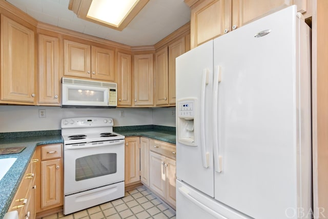 kitchen featuring white appliances and dark countertops