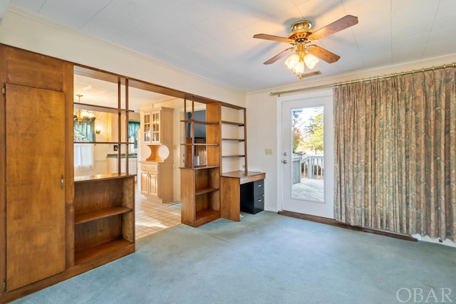 interior space with ornamental molding, carpet flooring, and ceiling fan with notable chandelier