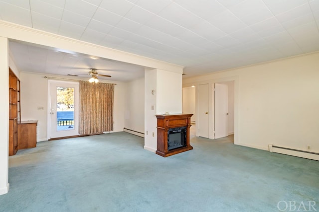 unfurnished living room featuring a ceiling fan, a baseboard heating unit, carpet flooring, and a glass covered fireplace