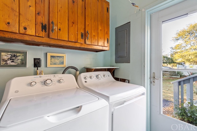 laundry room with independent washer and dryer, cabinet space, and electric panel