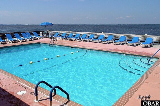 view of pool with a water view