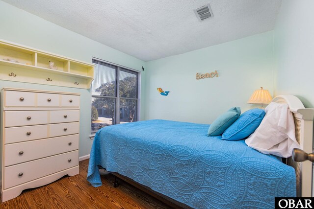 314 Pirates Way Unit 314B, Manteo, NC 27954 - bedroom with wood finished floors and a textured ceiling