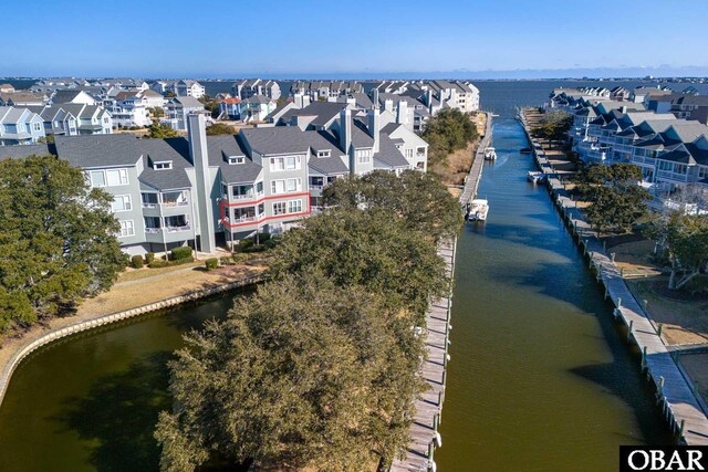 drone / aerial view with a water view and a residential view