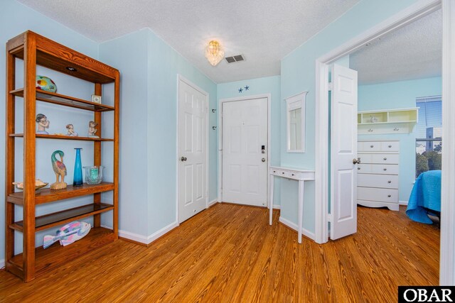 314 Pirates Way Unit 314B, Manteo, NC 27954 - foyer entrance with wood finished floors, a textured ceiling, and baseboards