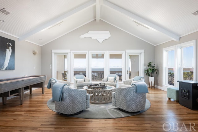 living room featuring visible vents, beamed ceiling, baseboards, and wood finished floors