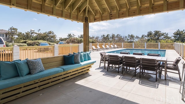 view of patio with a fenced in pool, outdoor dining area, outdoor lounge area, and a gazebo