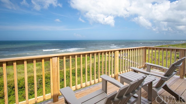 wooden deck with a water view and a view of the beach