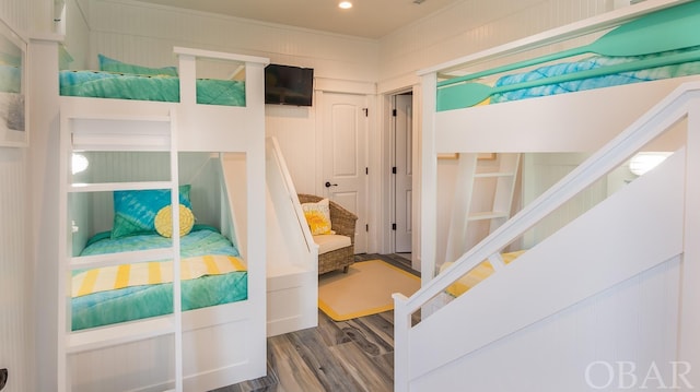 bedroom featuring a closet, wood finished floors, and recessed lighting