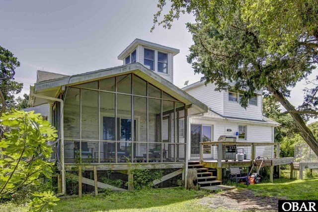 155 Loop Rd Lot 5, Ocracoke, NC 27960 - back of property with a sunroom and a wooden deck