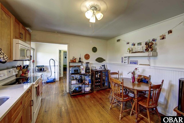155 Loop Rd Lot 5, Ocracoke, NC 27960 - dining space featuring a ceiling fan, wainscoting, and dark wood finished floors