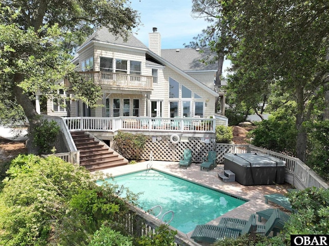 1148 Dunton Dr Lot 337, Corolla, NC 27927 - back of property featuring roof with shingles, a hot tub, stairway, a chimney, and a patio area