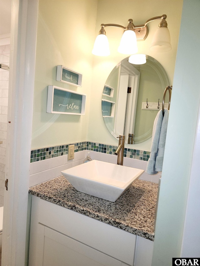 bathroom featuring decorative backsplash and vanity