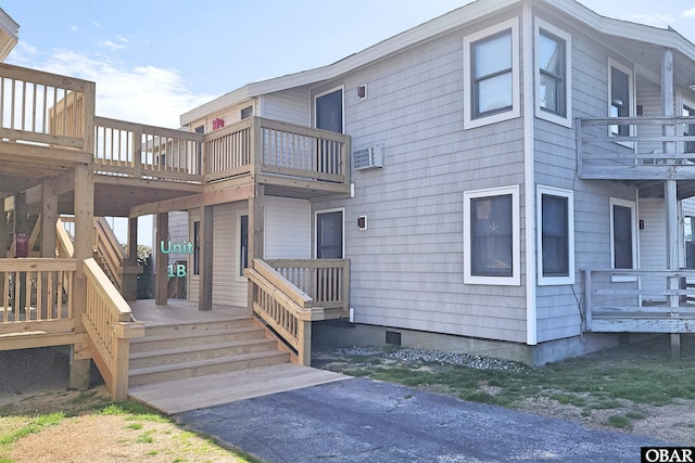 exterior space featuring crawl space and a wall unit AC