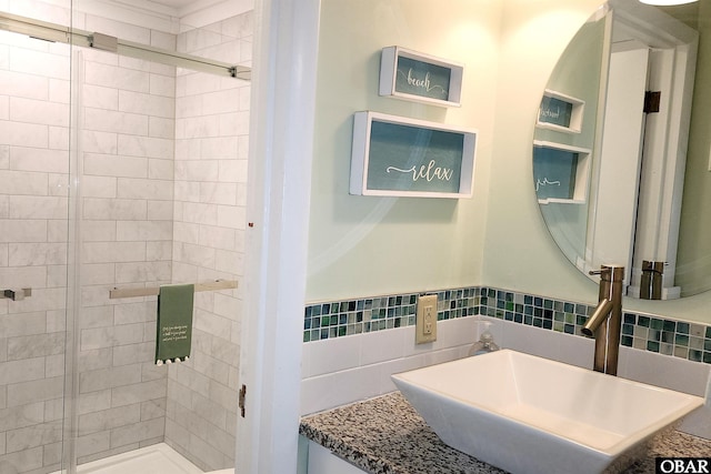 bathroom with a sink and a shower stall