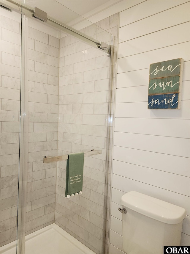 bathroom with a stall shower and toilet