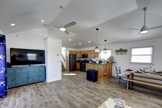 kitchen featuring dark countertops, stainless steel microwave, electric range, freestanding refrigerator, and ceiling fan